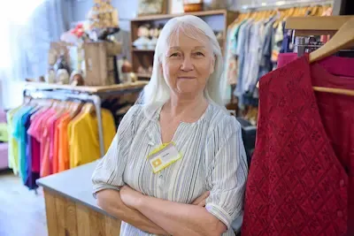 Smiling volunteer with a name tag standing in the store