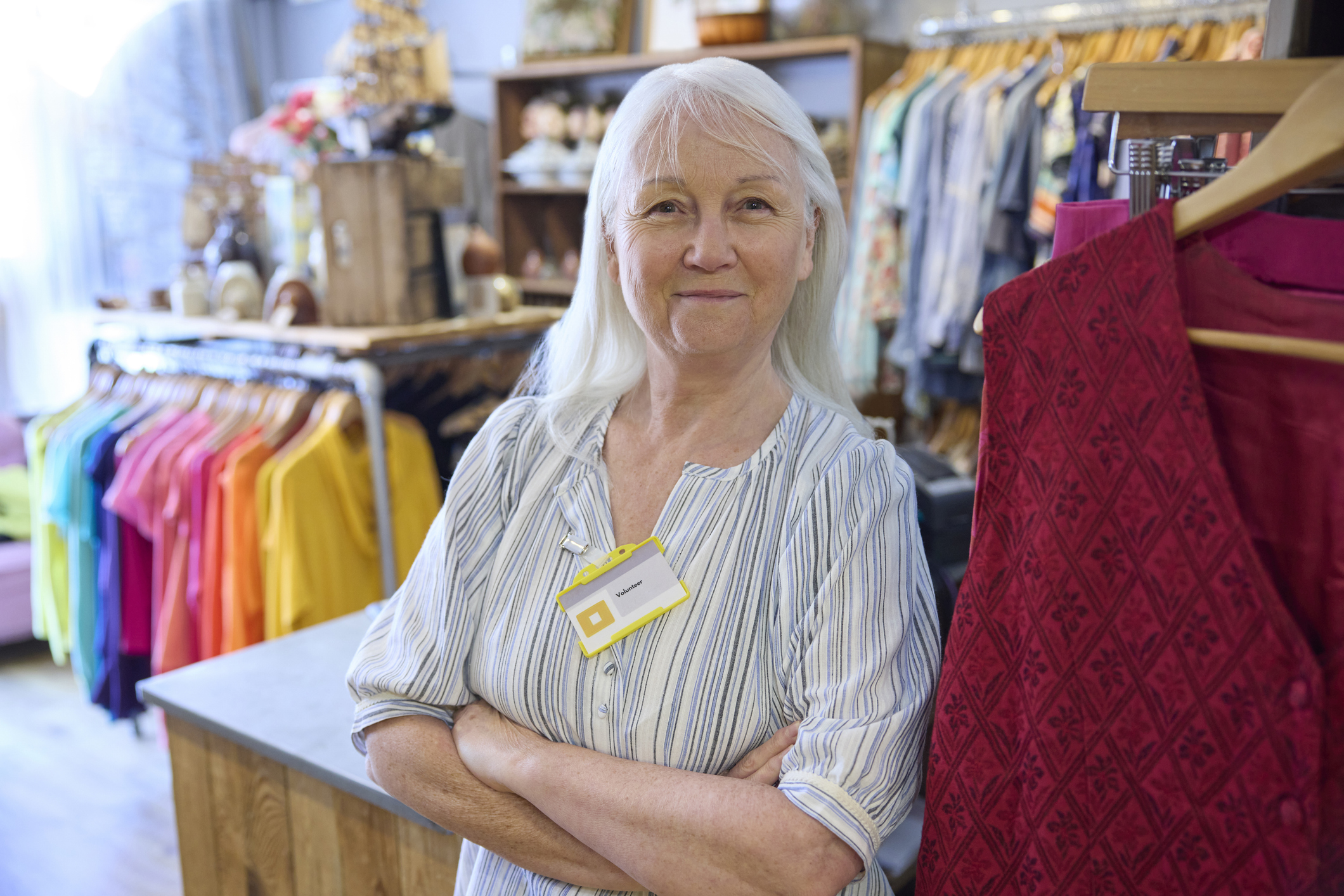 Smiling volunteer with a name tag standing in the store